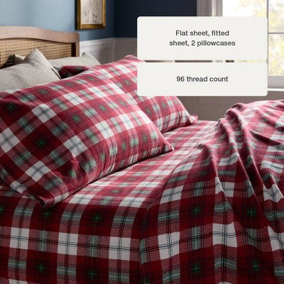 Threshold Holiday Flannel Sheet Set, Red colored tartan plaid sheet set with white colored and green colored accents on a made bed, with… #color_THRESHOLD Tartan