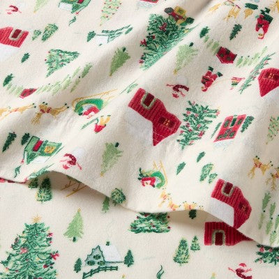 Threshold Holiday Flannel Sheet Set, Cream colored flannel sheet with a repeating winter scene pattern featuring green colored Christmas… #color_THRESHOLD Winter Scene