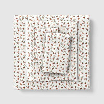 Wondershop Holiday Flannel Sheet Set, White colored sheet set folded and stacked, featuring a repeating mini holiday icon pattern with… #color_WS Mini Icon