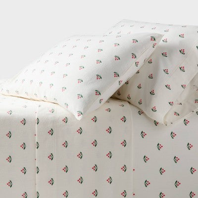 Threshold Holiday Flannel Sheet Set, Cream colored sheet set with a repeating small red berry and green leaf print on pillowcases and a… #color_THRESHOLD Berry