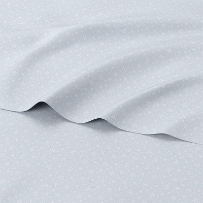 Wondershop Holiday Flannel Sheet Set, Light blue colored sheet set with white colored snowflake pattern draped to show the printed fabric… #color_WS Blue Snowflake Reactive